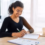 portrait-positive-young-woman-working-office_23-2148461499