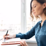 side-view-woman-making-notes-her-diary_171337-12885