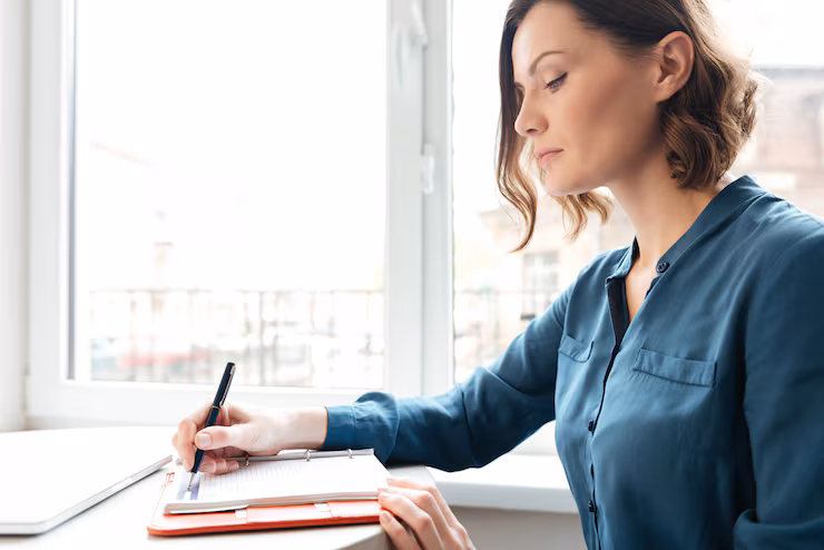 side-view-woman-making-notes-her-diary_171337-12885